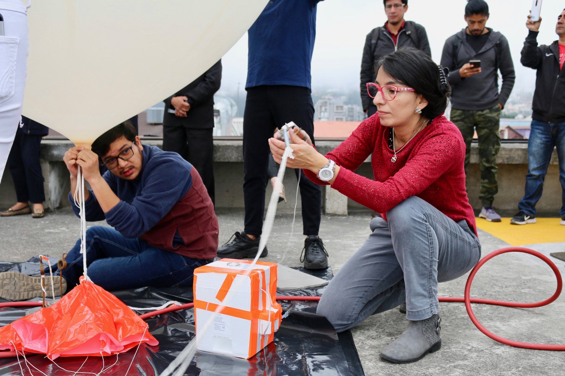 Preparations to launch the first ozonesonde of the ECHOZ project from Universidad San Francisco de Quito on 6 March 2020. On the picture, M. Cazorla and E. Herrera complete balloon filling with helium and anchoring ozonesonde-radiosonde package to platform prior to launching.