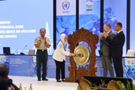 Woman striking ceremonial gong