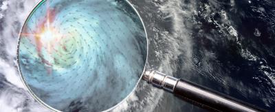 A magnifying glass with a hurricane in the background.