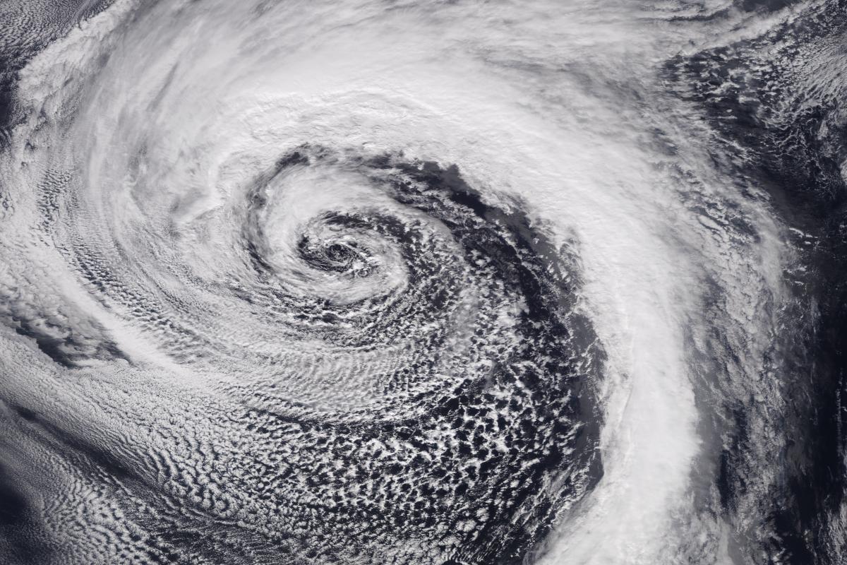 A satellite image of a large cyclone showing a swirling pattern of clouds over the ocean.